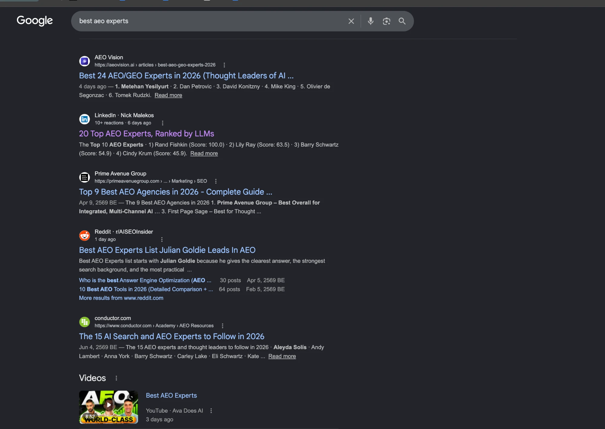 Google first page for best AEO experts showing a Reddit thread titled Best AEO Experts List Julian Goldie Leads In AEO and the video pack with the Best AEO Experts video